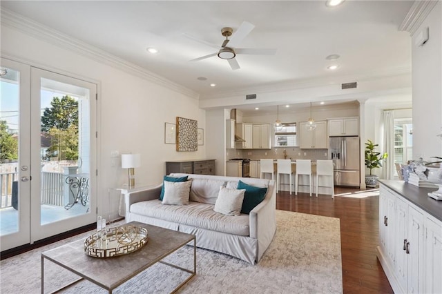 living room with french doors, dark hardwood / wood-style floors, ceiling fan, and crown molding