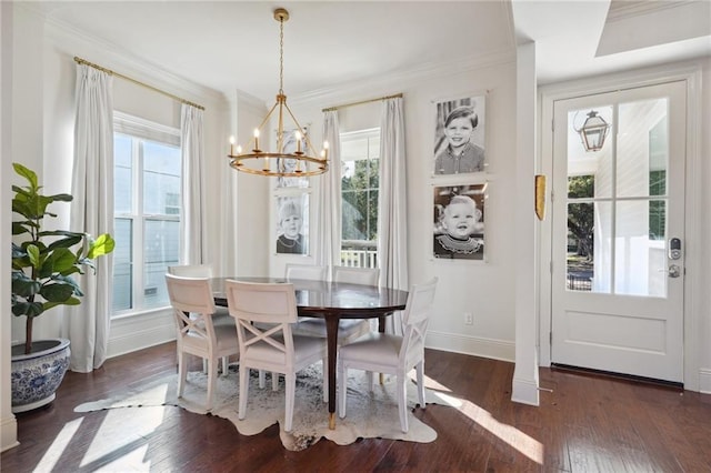 dining room with a notable chandelier, dark hardwood / wood-style flooring, and crown molding