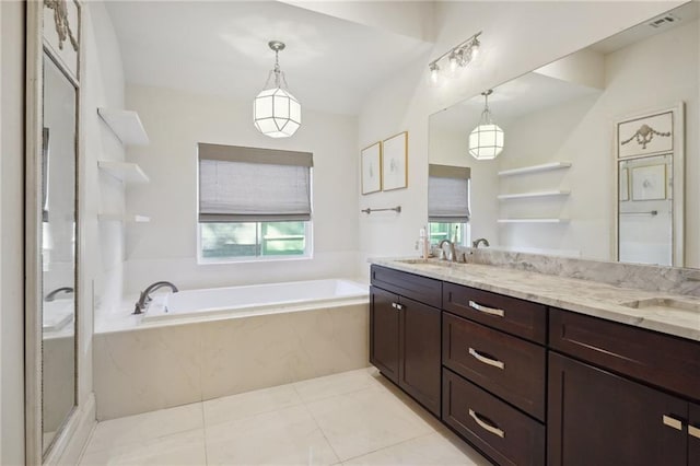 bathroom featuring tile patterned flooring, vanity, a healthy amount of sunlight, and separate shower and tub