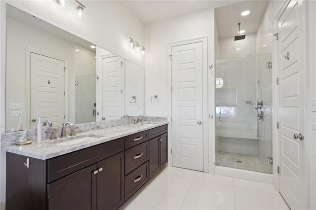 bathroom with vanity, tile patterned floors, and a shower with door