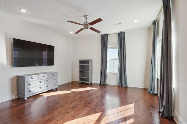 unfurnished living room with ceiling fan and dark hardwood / wood-style flooring