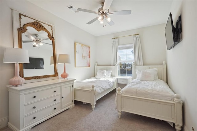 bedroom with ceiling fan and light carpet