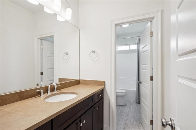 full bathroom featuring vanity, toilet, and washtub / shower combination