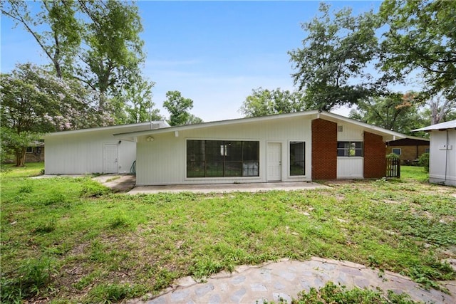 rear view of property with a patio area and a yard