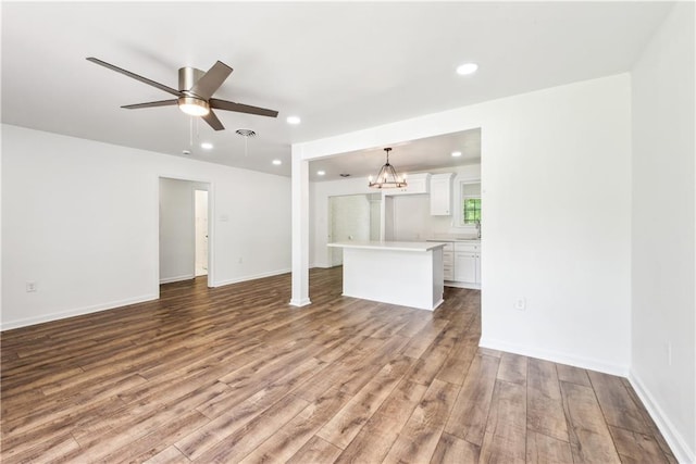 309 W Joan St, Gonzales, LA 70737 - unfurnished living room with hardwood / wood-style flooring and ceiling fan with notable chandelier