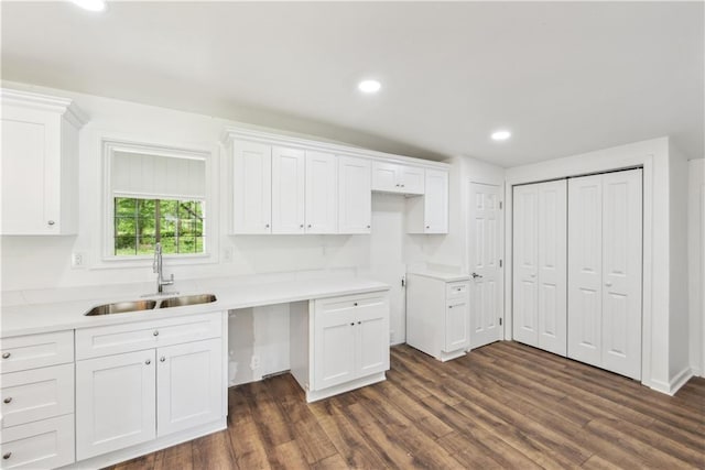 309 W Joan St, Gonzales, LA 70737 - kitchen featuring white cabinetry, sink, and dark wood-type flooring