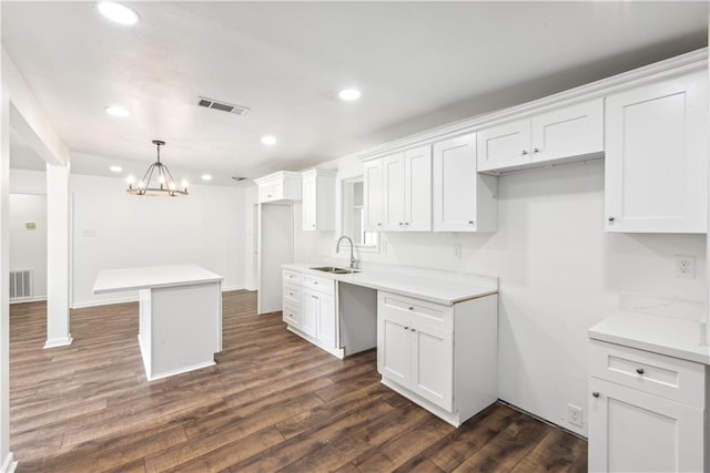 309 W Joan St, Gonzales, LA 70737 - kitchen featuring pendant lighting, a kitchen island, white cabinetry, and sink