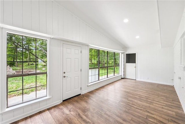 309 W Joan St, Gonzales, LA 70737 - unfurnished living room featuring hardwood / wood-style flooring, lofted ceiling, and a wealth of natural light