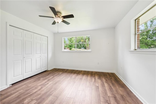 309 W Joan St, Gonzales, LA 70737 - unfurnished bedroom featuring ceiling fan, a closet, and wood-type flooring