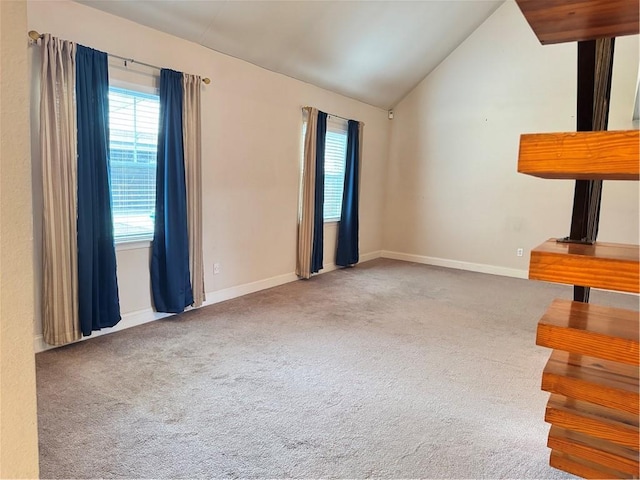 unfurnished living room with carpet flooring and lofted ceiling