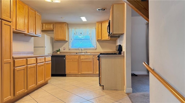 kitchen featuring dishwasher, sink, white refrigerator, light brown cabinetry, and light tile patterned flooring