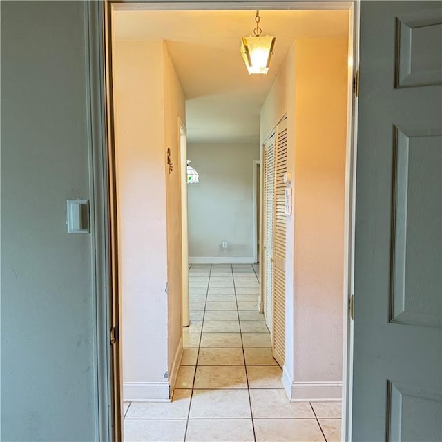 hall featuring light tile patterned floors