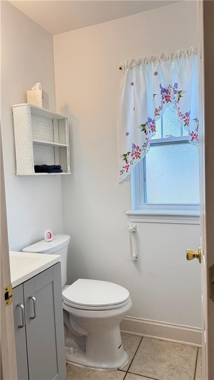 bathroom featuring tile patterned floors, vanity, and toilet