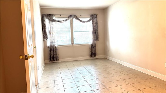 spare room featuring light tile patterned floors