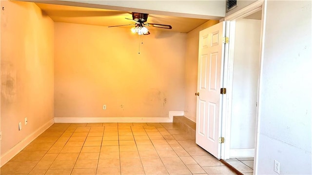 empty room with light tile patterned floors and ceiling fan