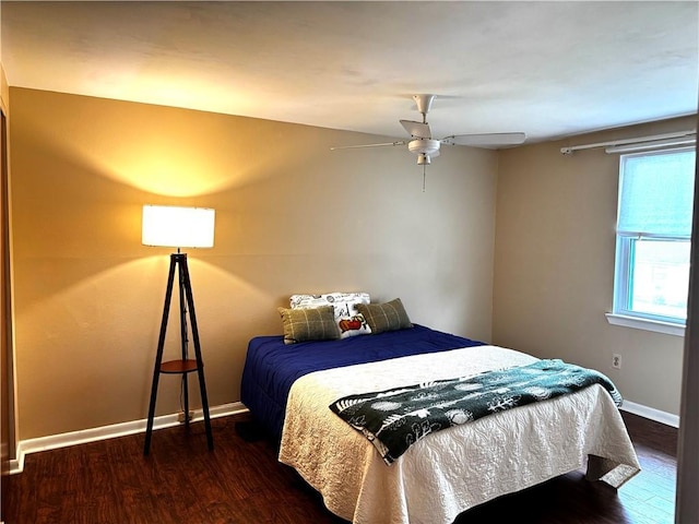 bedroom with ceiling fan and dark wood-type flooring