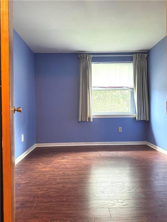 spare room featuring dark hardwood / wood-style flooring