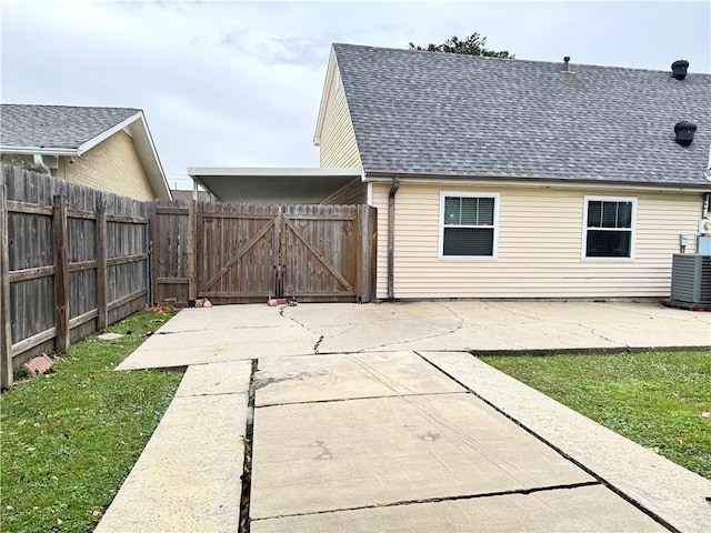 exterior space featuring a patio, central AC, and a lawn