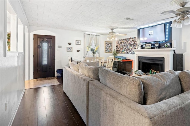 living room with ceiling fan and dark hardwood / wood-style floors