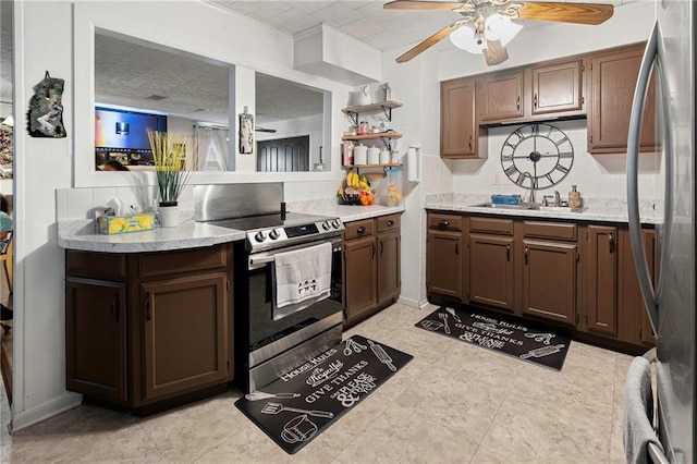 kitchen featuring sink, ceiling fan, decorative backsplash, dark brown cabinets, and stainless steel appliances