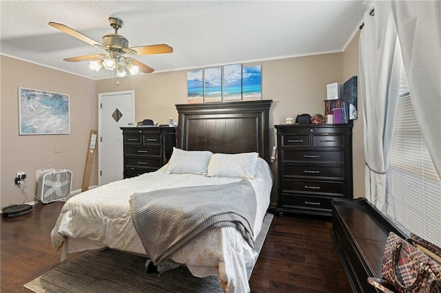 bedroom with dark hardwood / wood-style floors, ceiling fan, and ornamental molding