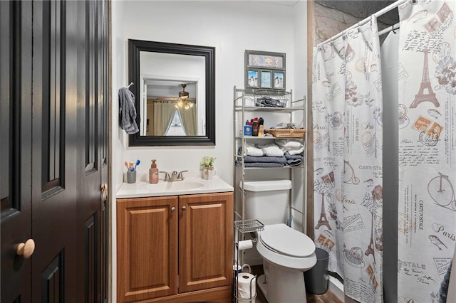 bathroom with walk in shower, vanity, and toilet