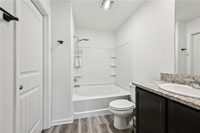 full bathroom with hardwood / wood-style floors, vanity, shower / bathtub combination, and toilet