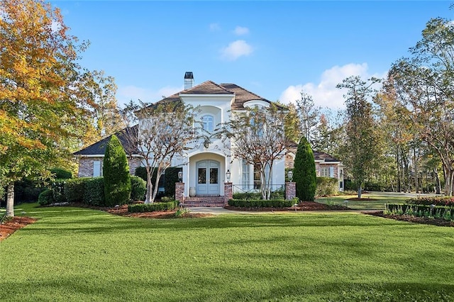 view of front facade featuring a front lawn and french doors