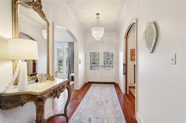 entryway featuring crown molding, french doors, and hardwood / wood-style floors