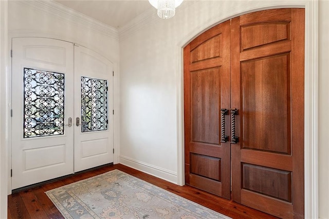 entryway with french doors, dark hardwood / wood-style floors, and ornamental molding