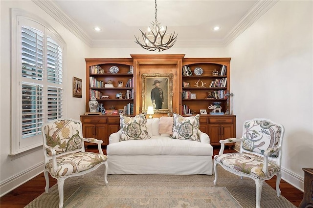 living area with hardwood / wood-style floors, ornamental molding, and a notable chandelier