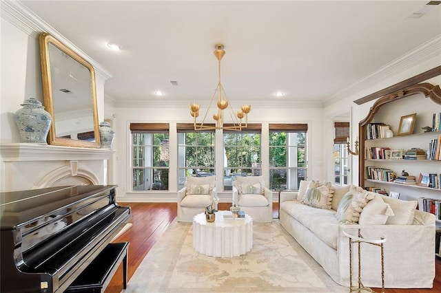 living room featuring crown molding, wood-type flooring, and a notable chandelier