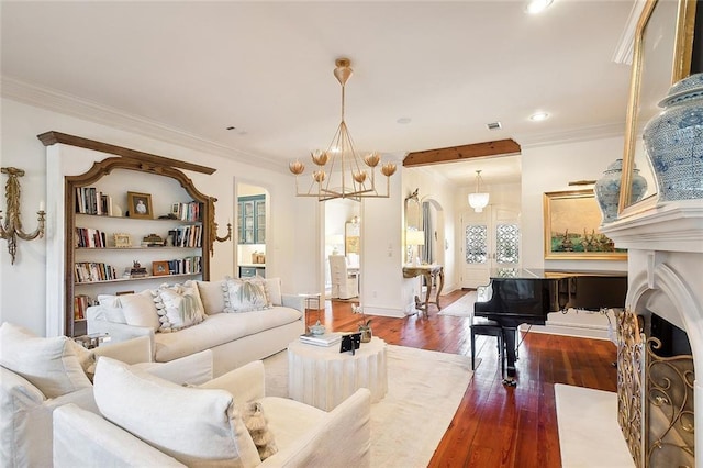 living room featuring ornamental molding, a notable chandelier, and hardwood / wood-style flooring