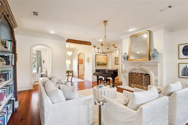 living room with an inviting chandelier, wood-type flooring, and ornamental molding