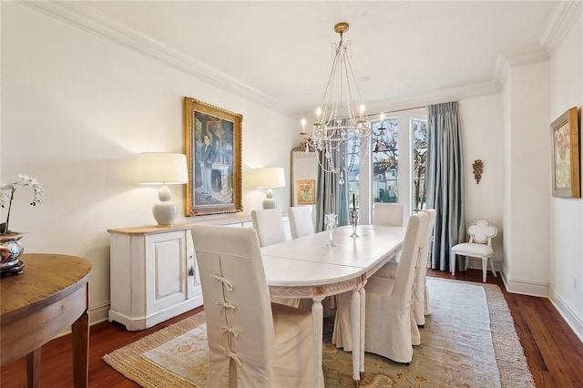 dining space featuring crown molding, dark hardwood / wood-style floors, and an inviting chandelier