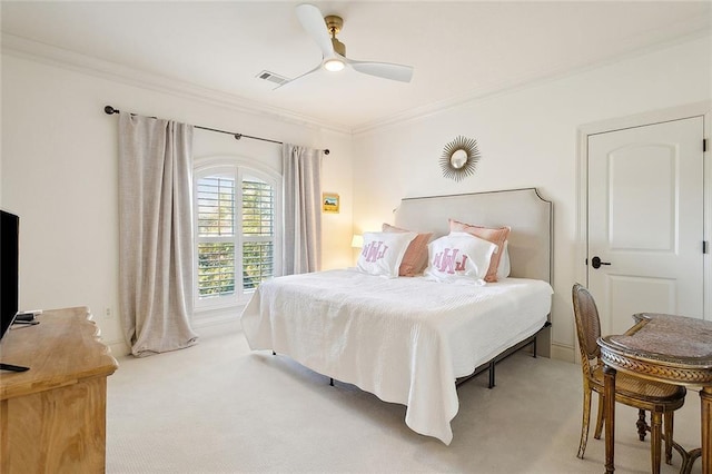 carpeted bedroom featuring ceiling fan and crown molding