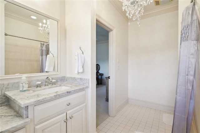 bathroom featuring tile patterned floors, crown molding, vanity, and an inviting chandelier