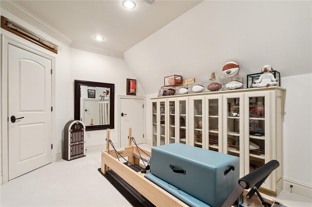 exercise room featuring light colored carpet, lofted ceiling, and crown molding