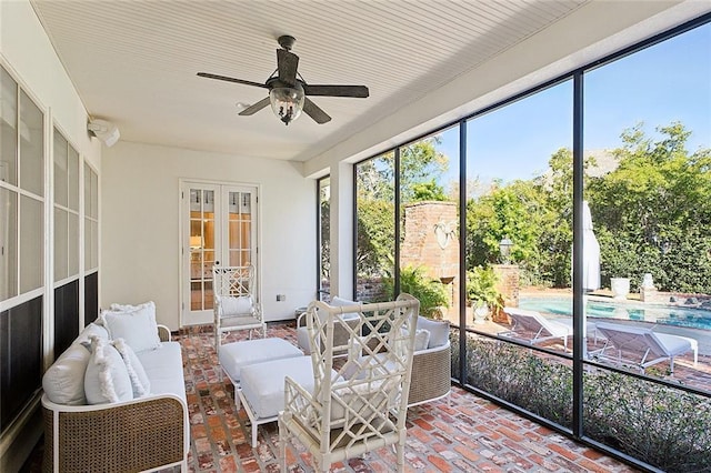 sunroom featuring ceiling fan