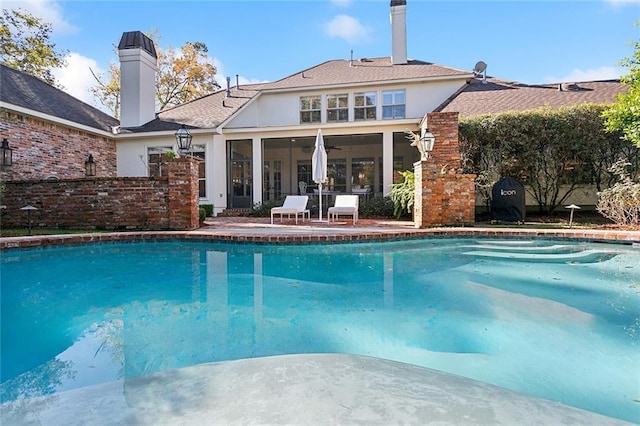 view of pool featuring a sunroom and a patio area