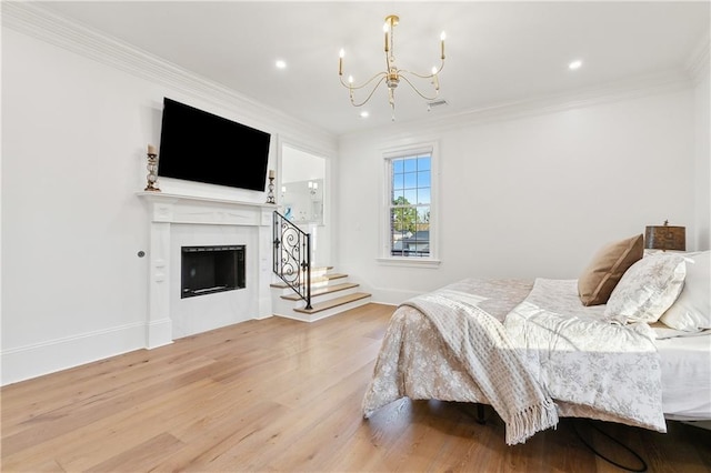 bedroom featuring a chandelier, wood-type flooring, and ornamental molding