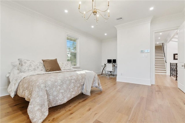 bedroom with light hardwood / wood-style flooring, a notable chandelier, and ornamental molding