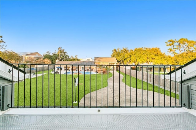 view of gate with a lawn