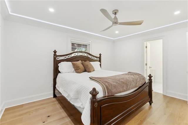 bedroom featuring ceiling fan, light hardwood / wood-style floors, and ornamental molding