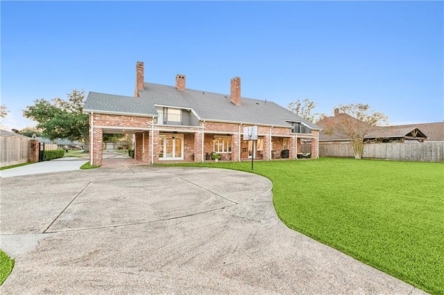 rear view of house with a yard