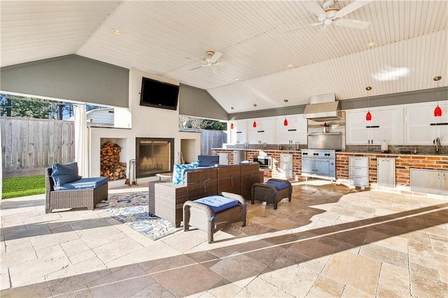 view of patio with outdoor lounge area, ceiling fan, a grill, and sink