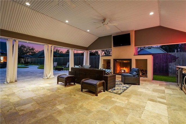 view of patio / terrace featuring an outdoor living space with a fireplace and ceiling fan