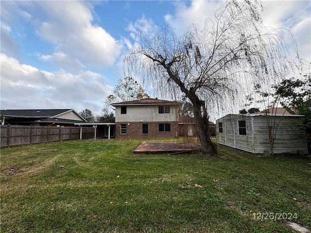 back of property featuring a lawn and a patio area