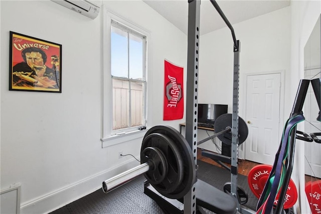 workout room with baseboards and a wall mounted AC