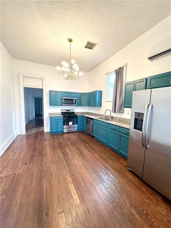 kitchen featuring a sink, visible vents, light countertops, appliances with stainless steel finishes, and pendant lighting